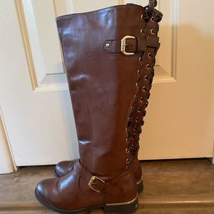 Brown lace up riding boots with gold accents